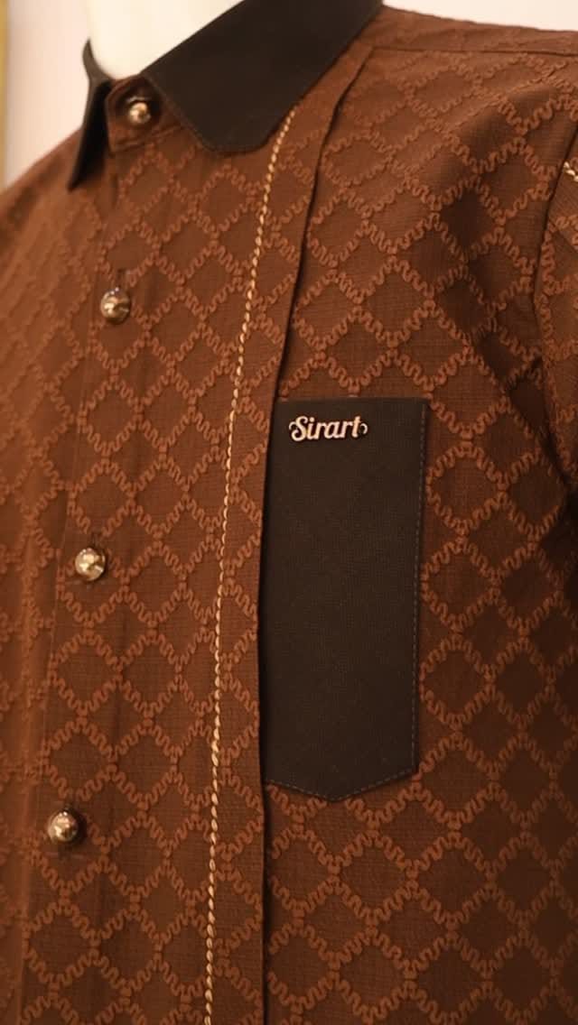 Rich brown jacquard-weave kaftan with black pocket on a mannequin, texture close-up
