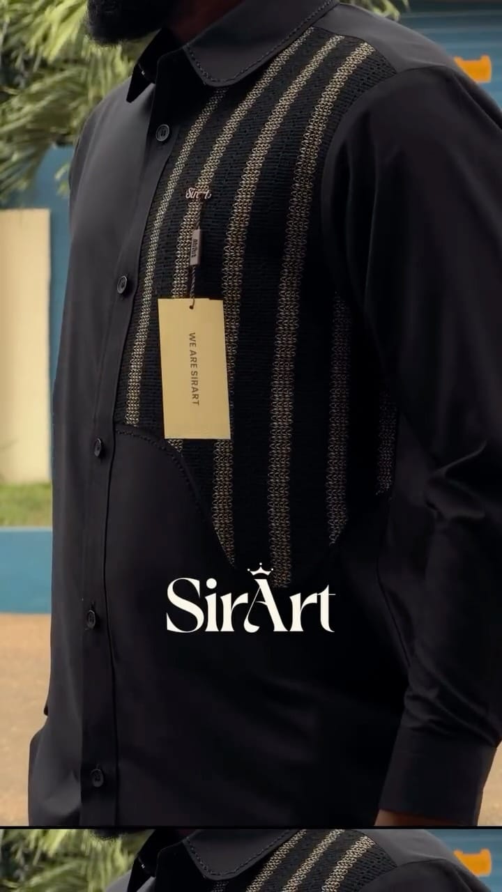 Black kaftan with woven gold vertical stripes, worn with a garment tag still attached