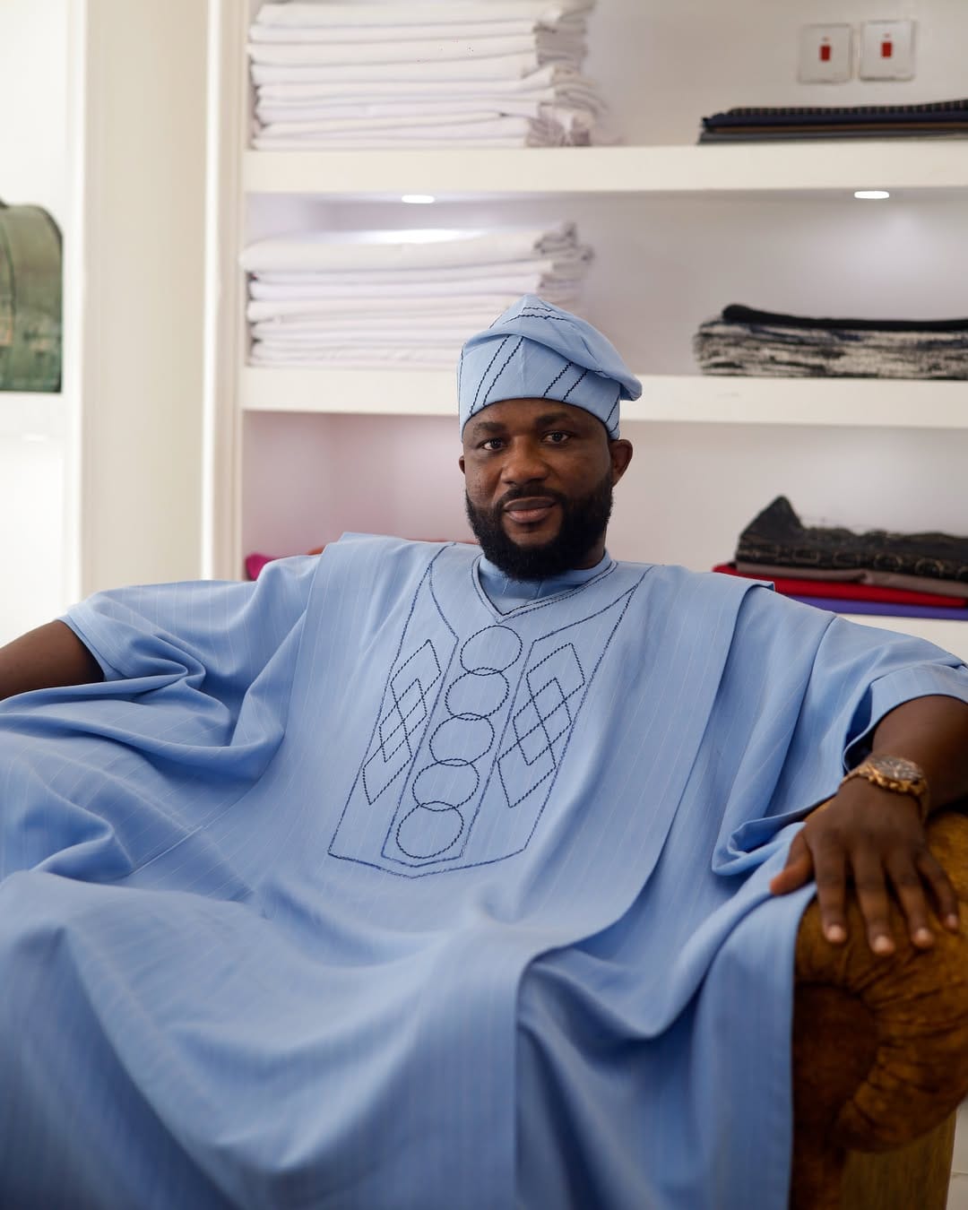 Steve Maduguh, founder and creative director of SirArt, in a sky-blue embroidered agbada in the Accra showroom